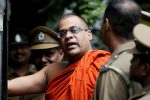 Galaboda Aththe Gnanasara Thero, head of Buddhist group Bodu Bala Sena (BBS), walks towards a prison bus while accompanied by prison officers after he was sentenced by a court for threatening Sandya Eknelygoda, wife of missing journalist Prageeth Eknaligoda, in Homagama, Sri Lanka June 14, 2018. REUTERS/Dinuka Liyanawatte