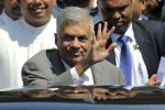 Sri Lankan Prime Minister Ranil Wickremesinghe waves to media as he leaves after appearing before a presidential commission of inquiry into issuance of treasury bonds in Colombo, Sri Lanka, Monday, Nov. 20, 2017. (AP Photo/Eranga Jayawardena)