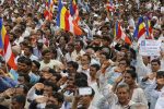 Members of IndiaÄôs low-caste Dalit community salute the Indian flag they hoisted as they gather for a rally in Una, Gujarat state, India, Monday, Aug. 15, 2016. The Dalits have been protesting since four men belonging to their community were beaten while trying to skin a dead cow in July near this western Indian town. Videos of the four being stripped and beaten with sticks by men claiming to be cow protectors in Gujarat state had gone viral and sparked protests by Dalit groups across India. The Dalits, belong to the lowest rung of Hinduism's caste hierarchy. (AP Photo/Ajit Solanki)