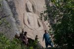 This photo taken on April 26, 2018 shows Pakistani visitors walking past the seventh-century rock sculpture of a seated Buddha carved into a mountain in Jahanabad town in the northwestern Swat Valley of Pakistan, following a restoration process conducted by Italian archaeologists after the Taliban defaced it in 2007.
The Buddha of Swat, carved on a cliff in the seventh century, was dynamited by the Pakistani Taliban in 2007. Now it has been restored, a powerful symbol of tolerance in the traumatised Pakistani valley. / AFP PHOTO / ABDUL MAJEED / TO GO WITH Pakistan-archaeology-Buddha-Swat,FEATURE by Amelie Herenstein