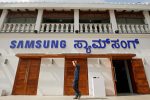 FILE PHOTO - A man walks past a newly opened Samsung store in Bengaluru, India, September 11, 2018. REUTERS/Abhishek N. Chinnappa