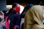 A woman wearing protective mask looks on as she waits for a commuter train at a station in Jakarta, Indonesia March 2, 2020. REUTERS/Willy Kurniawan - RC2NBF9YHV3C