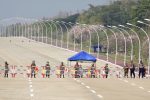 Soldiers stand guard on a blockaded road to Myanmar's parliament in Naypyidaw on February 1, 2021, after the military detained the country's de facto leader Aung San Suu Kyi and the country's president in a coup. (Photo by STR / AFP)