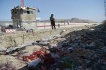 TOPSHOT - A Taliban fighter stands guard at the site of the August 26 twin suicide bombs, which killed scores of people including 13 US troops, at Kabul airport on August 27, 2021. (Photo by WAKIL KOHSAR / AFP) (Photo by WAKIL KOHSAR/AFP via Getty Images)