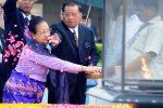 Myanmar military ruler Senior General Than Shwe (R) and his wife Daw Kyaing Kyaing (L) sprinkle rose petals as they pay tribute at Rajghat, a memorial for Mahatma Gandhi, during a visit in New Delhi on July 27, 2010. Than Shwe received a red-carpet welcome in New Delhi as he began the formal leg of a state visit to India amid protests and criticism from rights groups. AFP PHOTO/ Prakash SINGH (Photo by PRAKASH SINGH / AFP)