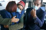 Danny Fenster, center, hugs his mother Rose Fenster as Bill Richardson, right, looks on at John F. Kennedy Airport in New York, Tuesday, Nov. 16, 2021. The American journalist, who spent nearly six months in jail in military-ruled Myanmar, has arrived in the United States. Fenster was sentenced last week to 11 years of hard labor. He was handed over Monday to former U.S. diplomat Bill Richardson, who helped negotiate the release. (AP Photo/Seth Wenig)