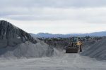 Digger in the midst of black sand tails in a lava sand pit in Iceland